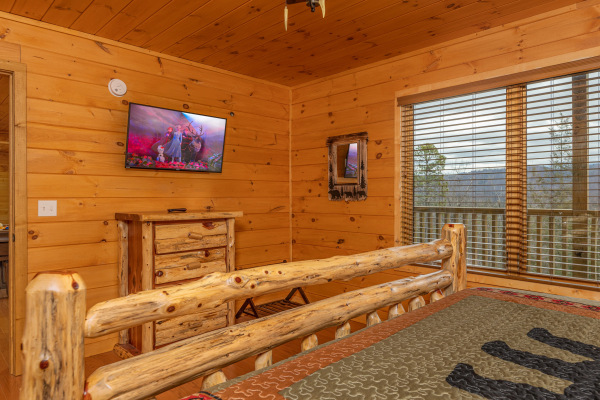 Dresser and TV in a bedroom at J's Hideaway, a 4 bedroom cabin rental located in Pigeon Forge