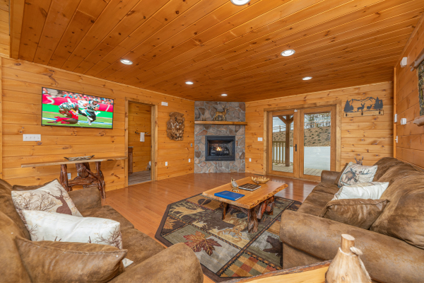 Fireplace and TV in a living room at J's Hideaway, a 4 bedroom cabin rental located in Pigeon Forge