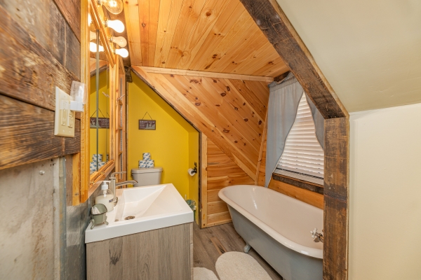 Small bathroom with a clawfoot tub at A Mountain Hyde-a Way, a 2 bedroom cabin rental located in Pigeon Forge