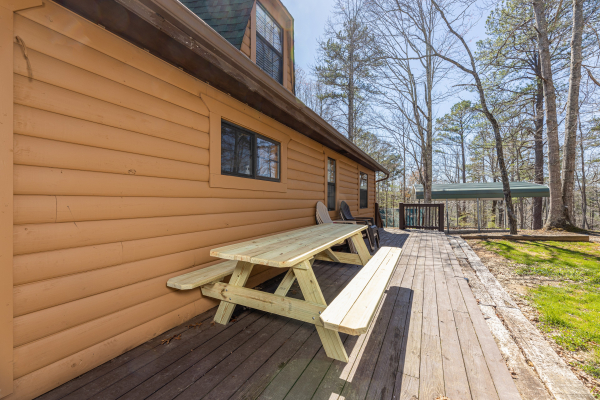 Picnic table on the deck at A Mountain Hyde-a Way, a 2 bedroom cabin rental located in Pigeon Forge