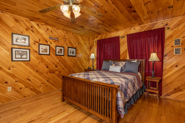 Bedroom with bed, two night stands, and lamps at Hatcher Mountain Retreat a 2 bedroom cabin rental located in Pigeon Forge