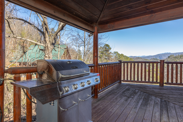 Gas grill on a covered deck at Hatcher Mountain Retreat a 2 bedroom cabin rental located in Pigeon Forge
