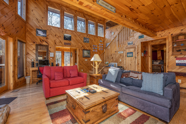 Sofa and loveseat in a living room at Hatcher Mountain Retreat a 2 bedroom cabin rental located in Pigeon Forge