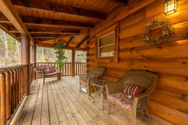 Two chairs and a loveseat on the deck at Absolutely Wonderful, a 2 bedroom cabin rental located in Pigeon Forge