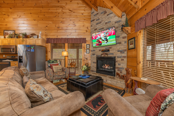 Living room with fireplace and TV at Absolutely Wonderful, a 2 bedroom cabin rental located in Pigeon Forge