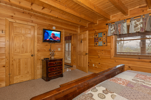 TV and dresser in a bedroom at Absolutely Wonderful, a 2 bedroom cabin rental located in Pigeon Forge