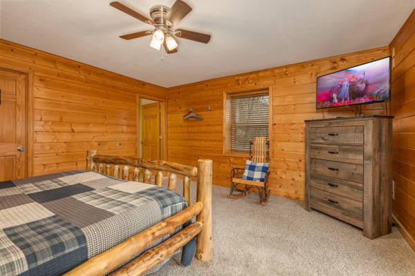Dresser, rocking chair, and TV in a bedroom at Smoky Mountain Escape, a 3 bedroom cabin rental located in Pigeon Forge