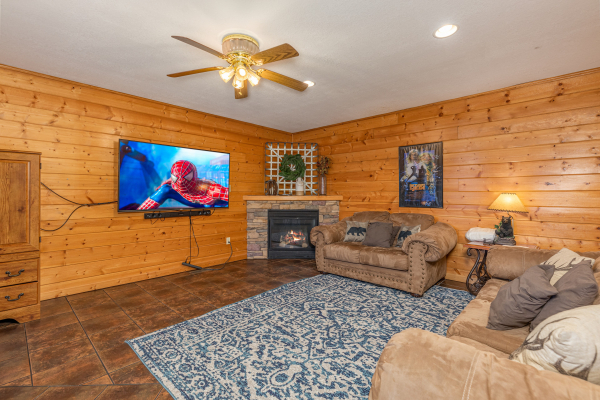Fireplace and TV downstairs at Smoky Mountain Escape, a 3 bedroom cabin rental located in Pigeon Forge