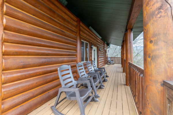 Rocking chairs on a covered deck at Smoky Mountain Escape, a 3 bedroom cabin rental located in Pigeon Forge