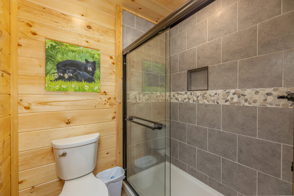 Shower and tub in a bathroom at Poolin Around, a 2 bedroom cabin rental located in Gatlinburg