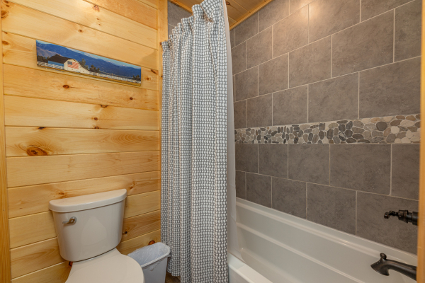 Bathroom with a tub and shower at Poolin Around, a 2 bedroom cabin rental located in Gatlinburg