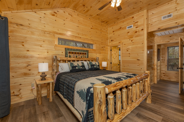 King bed, night stands, and lamps in a bedroom at Poolin Around, a 2 bedroom cabin rental located in Gatlinburg
