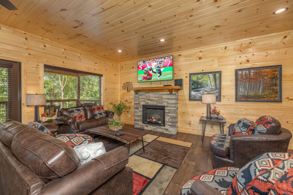 Living room seating with TV and Fireplace at Heavenly Daze, a 4 bedroom cabin rental located in Pigeon Forge