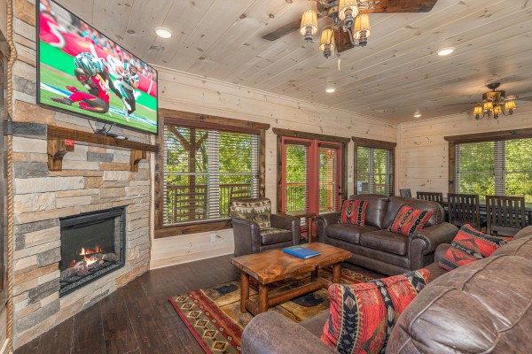 Fireplace and TV in a living room at Smoky Mountain Chalet, a 3 bedroom cabin rental located in Pigeon Forge