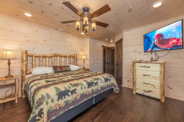 King bed, dresser, and TV in a bedroom at Smoky Mountain Chalet, a 3 bedroom cabin rental located in Pigeon Forge