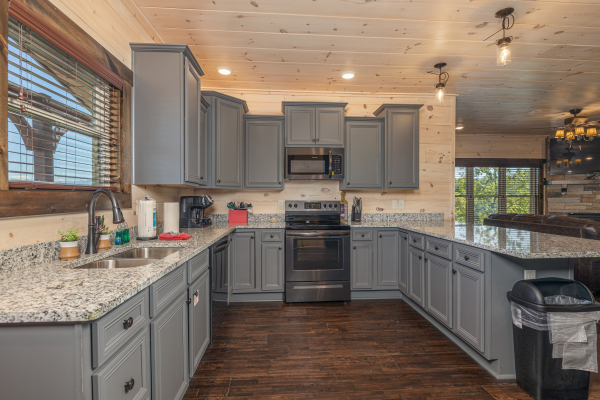 Kitchen with gray cabinets at Smoky Mountain Chalet, a 3 bedroom cabin rental located in Pigeon Forge