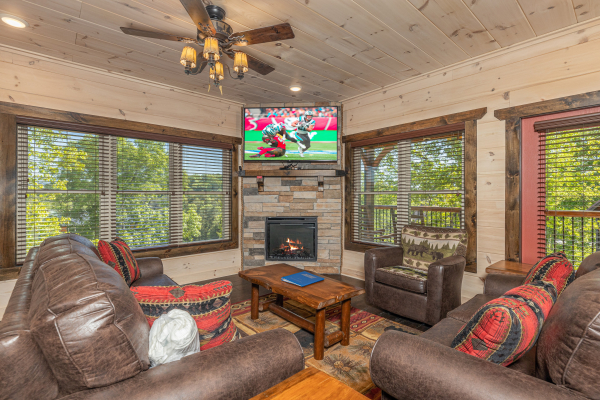 Fireplace and TV in a living room at Smoky Mountain Chalet, a 3 bedroom cabin rental located in Pigeon Forge