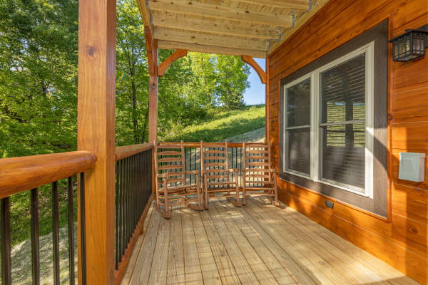 Lower deck with rocking chairs at Smoky Mountain Chalet, a 3 bedroom cabin rental located in Pigeon Forge
