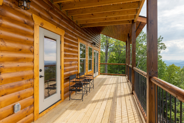 Covered deck with chairs at 4 States View, a 2 bedroom cabin rental located in Pigeon Forge