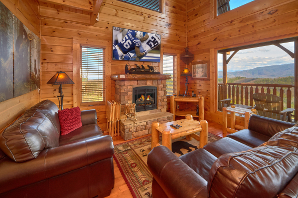 Living room, seating, fireplace, and TV with a view at Million Dollar View, a 2 bedroom cabin rental located in Pigeon Forge