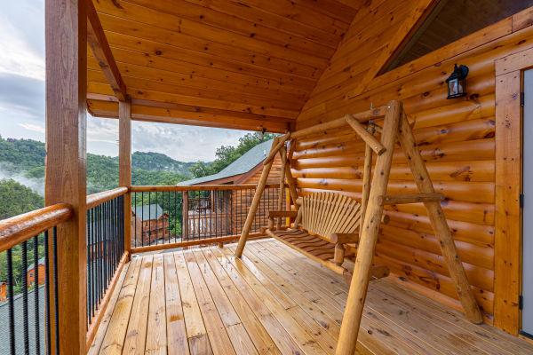 Deck swing at The One With The View, a 4 bedroom cabin rental located in Pigeon Forge
