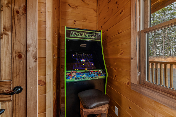 Arcade game at Four Seasons Grand, a 5 bedroom cabin rental located in Pigeon Forge