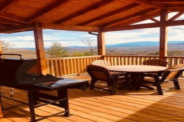 Grill and seating on deck with mountain view at Four Seasons Grand, a 5 bedroom cabin rental located in Pigeon Forge
