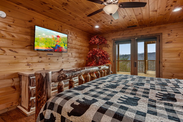 King bedroom amenities and balcony doors at Four Seasons Grand, a 5 bedroom cabin rental located in Pigeon Forge