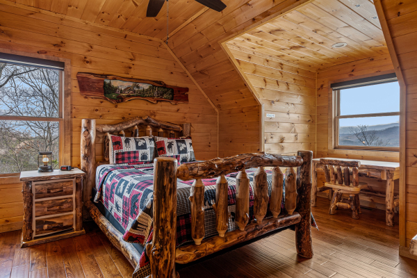 Bedroom with log furniture at Four Seasons Grand, a 5 bedroom cabin rental located in Pigeon Forge