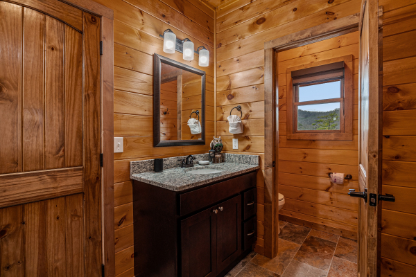 Master bathroom sink and toilet room at Four Seasons Grand, a 5 bedroom cabin rental located in Pigeon Forge