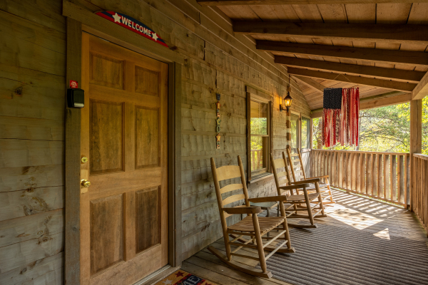 Porch seating at old glory, a 2 bedroom cabin rental located in Pigeon Forge