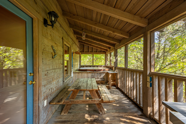 Seating on screened-in-porch at old glory, a 2 bedroom cabin rental located in Pigeon Forge