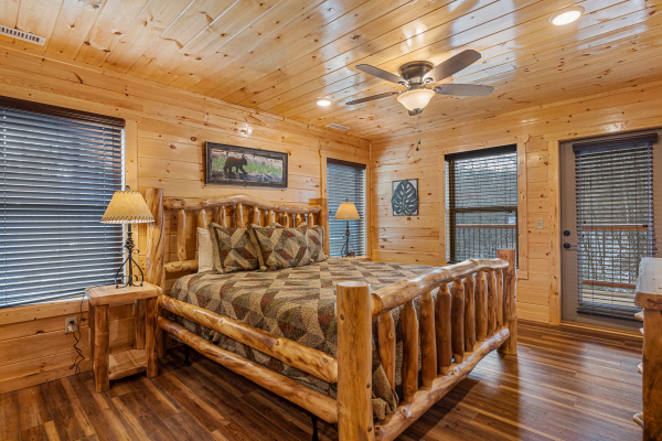Bedroom with log furniture and deck entry at Cool Pool Lodge