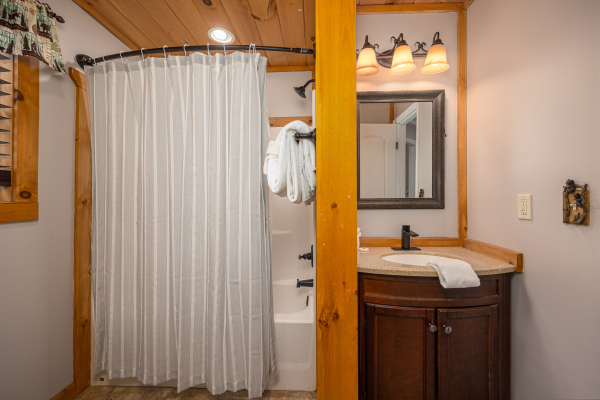 Bathroom with tub/shower combo at Hoop Dreams Lodge