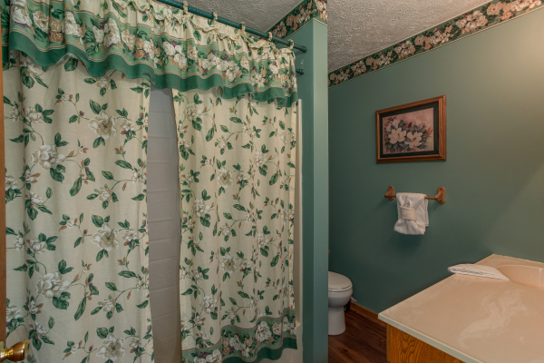 Bathroom with a tub and shower at Hideaway, a 1 bedroom cabin rental located in Pigeon Forge