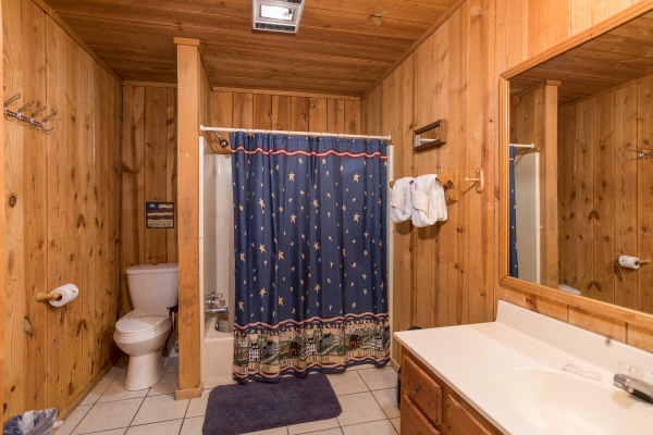 bathroom with tub and shower at america's view a 2 bedroom cabin rental located in pigeon forge