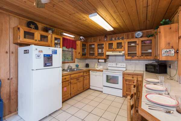 kitchen with white appliances at america's view a 2 bedroom cabin rental located in pigeon forge