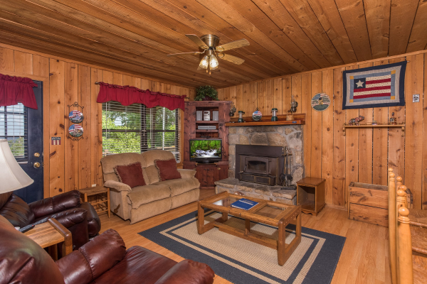 living room with wood burning fireplace at america's view a 2 bedroom cabin rental located in pigeon forge