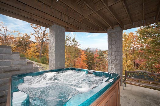Hot tub on the first floor patio at Big Bear Lodge, a 7-bedroom cabin rental located in Gatlinburg