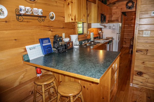 Breakfast bar for two in the kitchen at Seclusion, a 1 bedroom cabin rental located in Gatlinburg