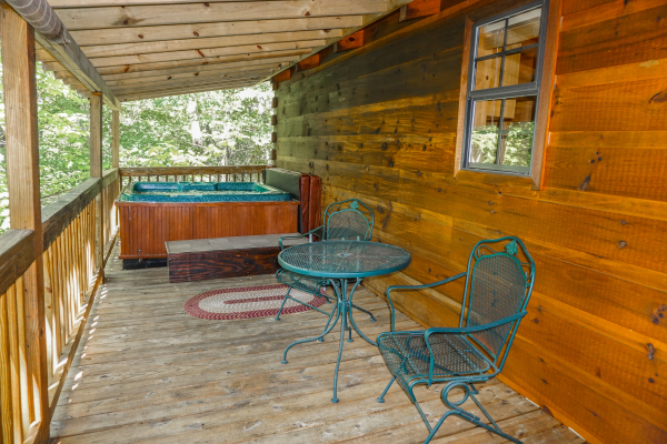 Patio table and chairs on the deck at Seclusion, a 1 bedroom cabin rental located in Gatlinburg