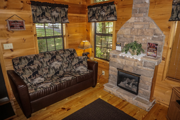 Sofa bed in the living room at Seclusion, a 1 bedroom cabin rental located in Gatlinburg