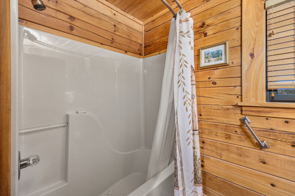 Bathroom with shower and bathtub at R & R Hideaway, a 1 bedroom cabin rental located in Pigeon Forge