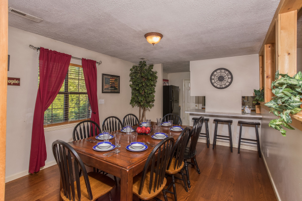 Dining table for 8 with counter seating for three at Patriot Pointe, a 5 bedroom cabin rental located in Pigeon Forge
