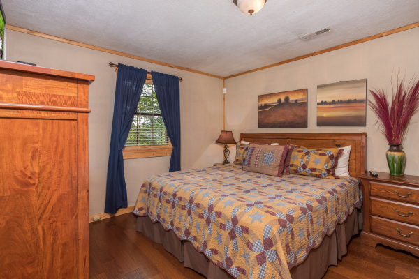 King sized bed at Patriot Pointe, a 5 bedroom cabin rental located in Pigeon Forge