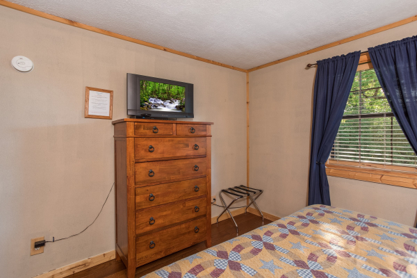 Chest of drawers and TV at Patriot Pointe, a 5 bedroom cabin rental located in Pigeon Forge