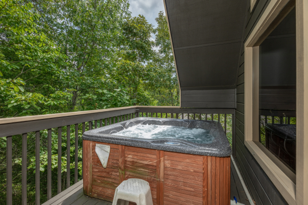Hot tub on a semi-covered deck at Amazing Memories, a 3 bedroom cabin rental located in Pigeon Forge