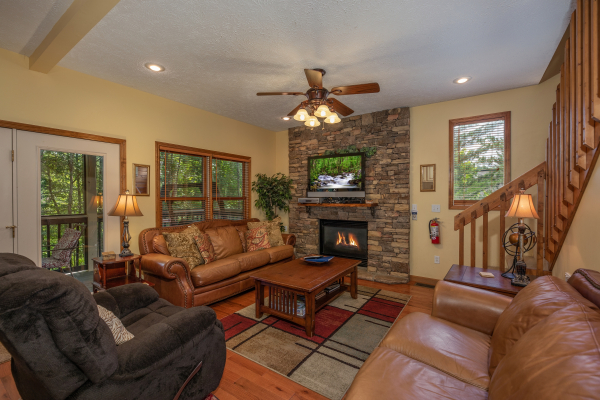 Living room with fireplace and TV at Amazing Memories, a 3 bedroom cabin rental located in Pigeon Forge