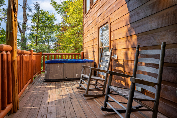 Deck seating near the hot tub at American Dream, a 2 bedroom cabin rental located in Gatlinburg