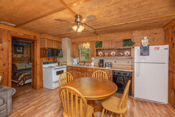 Dining room and kitchen at Heavenly Hideaway, a 2-bedroom cabin rental located in Gatlinburg